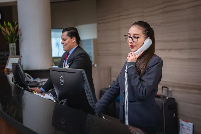 receptionists, phone call, hotel, reception, woman, man, work, attention, lobby, employees, professional, company, assistance, hotel, hotel, hotel, hotel, hotel, reception. Small Business Customer Retention Benchmarks: The Numbers and What Sits Behind Them