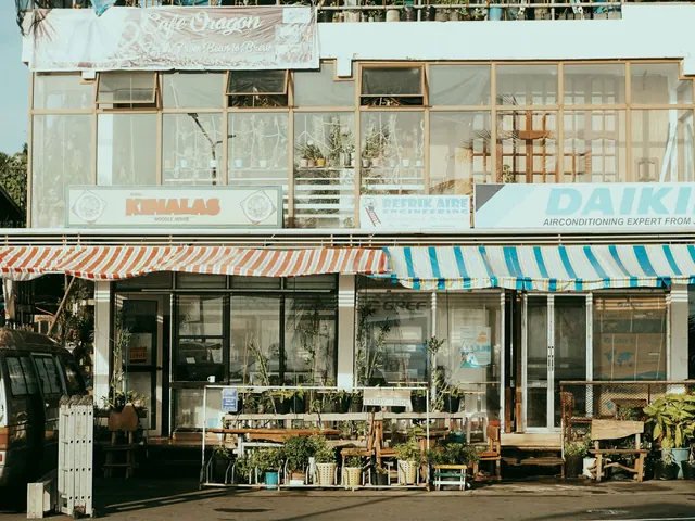 Charming street scene featuring local shops with colorful striped awnings and outdoor plants. Local SEO for Small Businesses: 2027 Guide