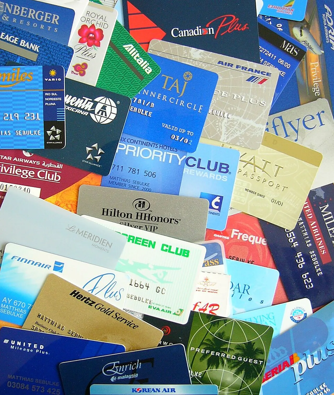 A collection of customer loyalty cards from airlines, hotels, and car rental companies.